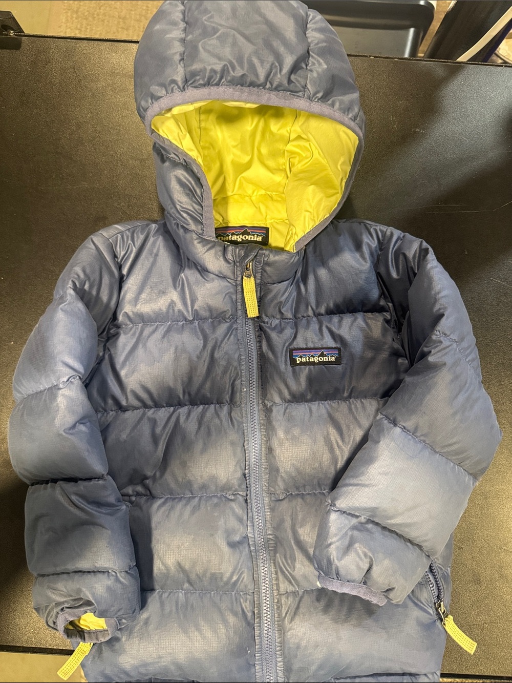 Patagonia kids puffer jacket in navy blue with yellow lining